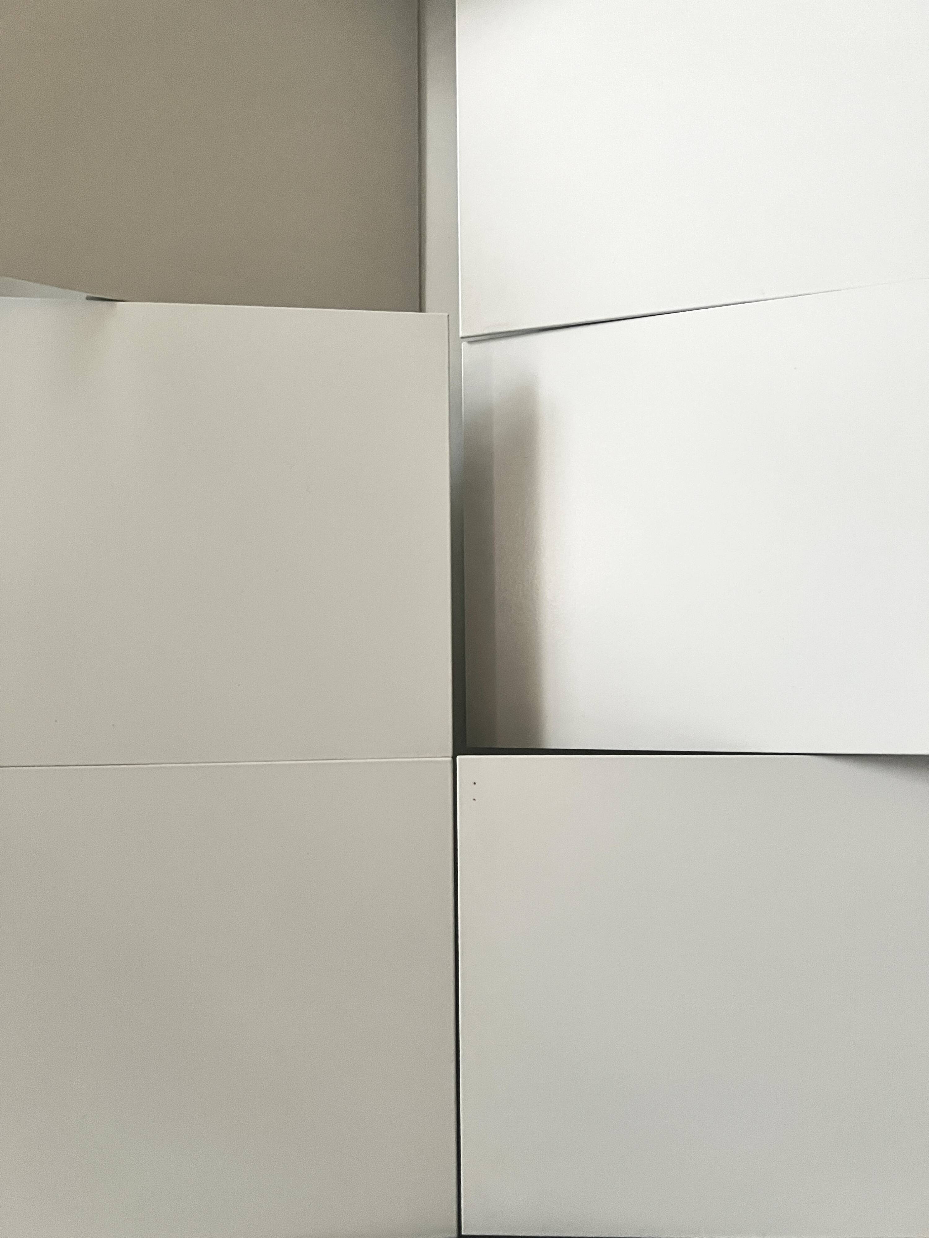 Modernist wall lamp with white metal shade, design by C. Grandidier.