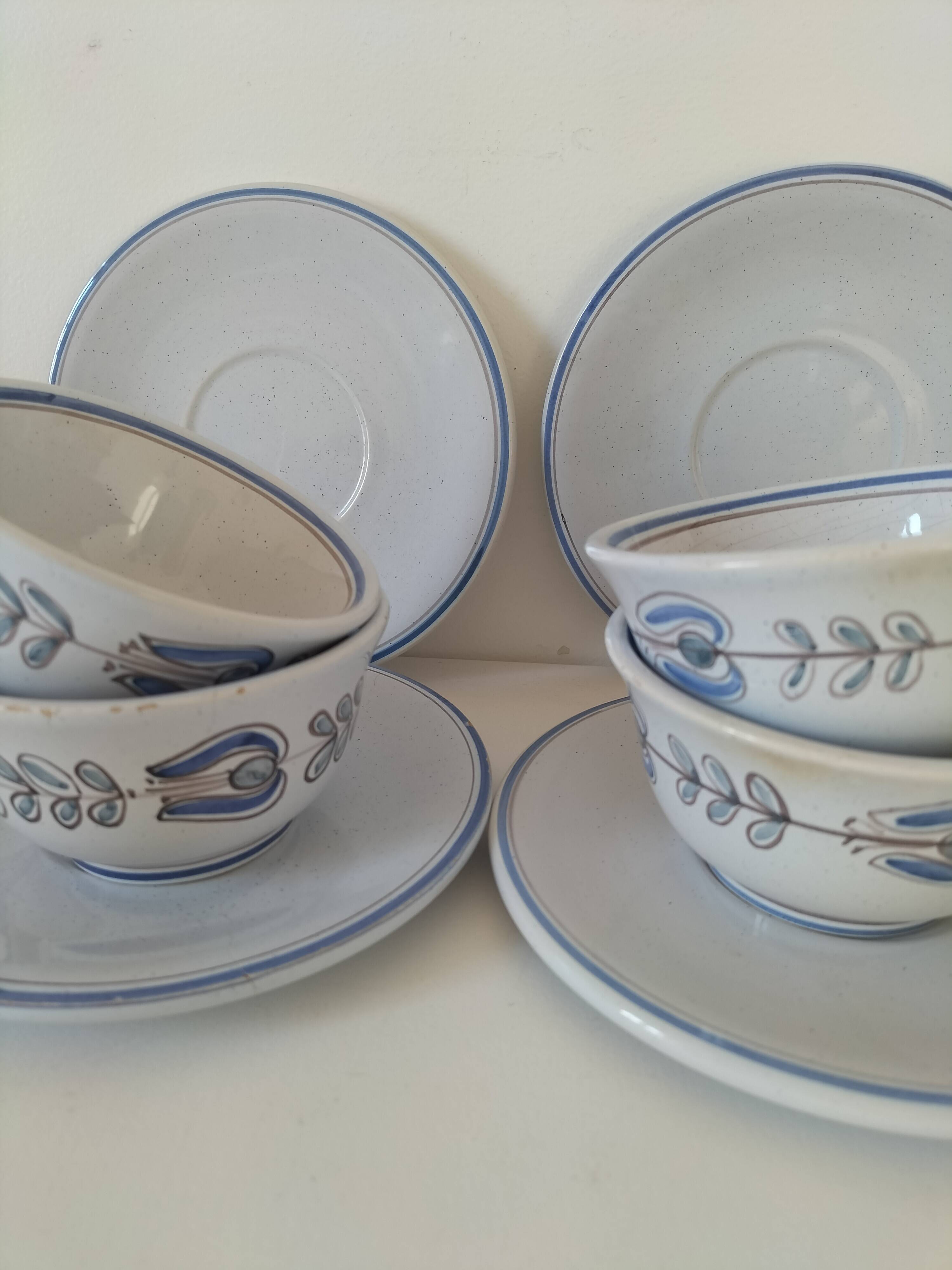 Glazed earthenware cups and saucers