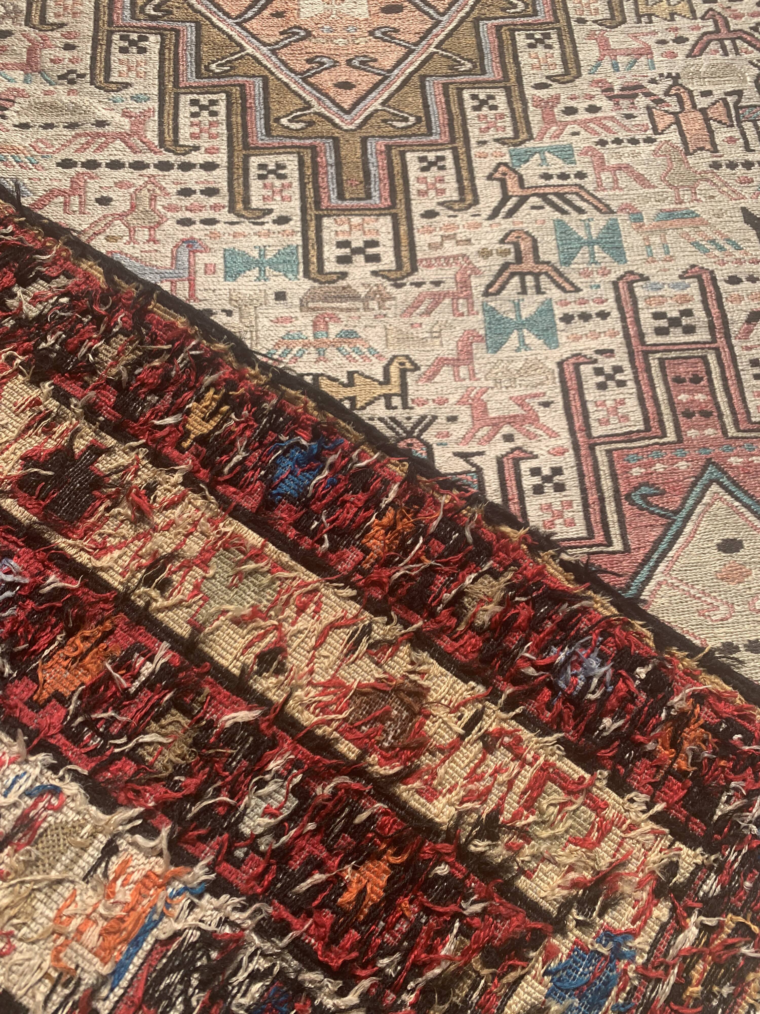 Hand-knotted silk carpet purchased in Iran – geometric and animal design –