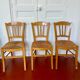 Trio of vintage straw/colored chairs