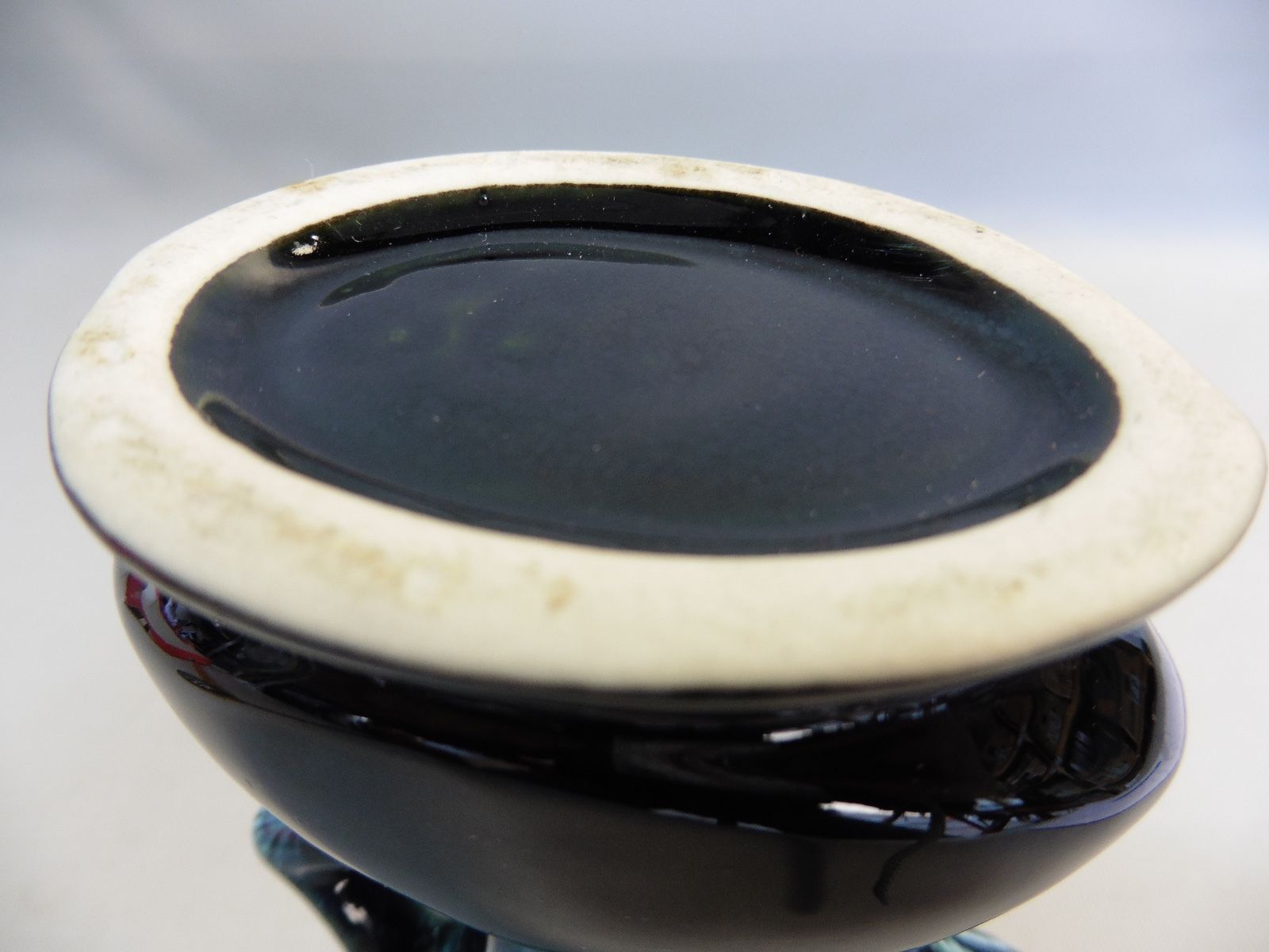 Praticality black and green vase numbered 666