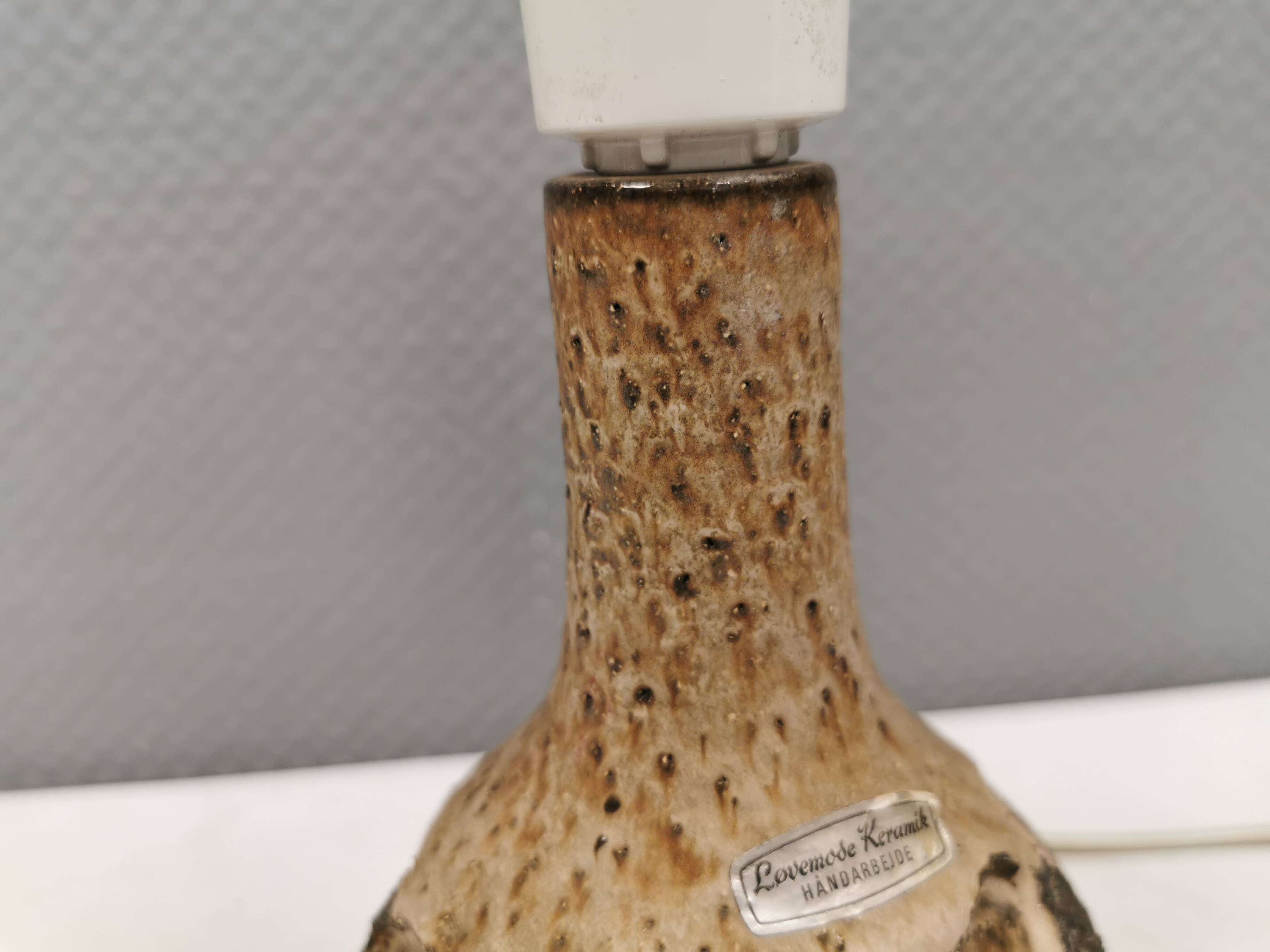 Small beautiful ceramic table lamp in earth colors.