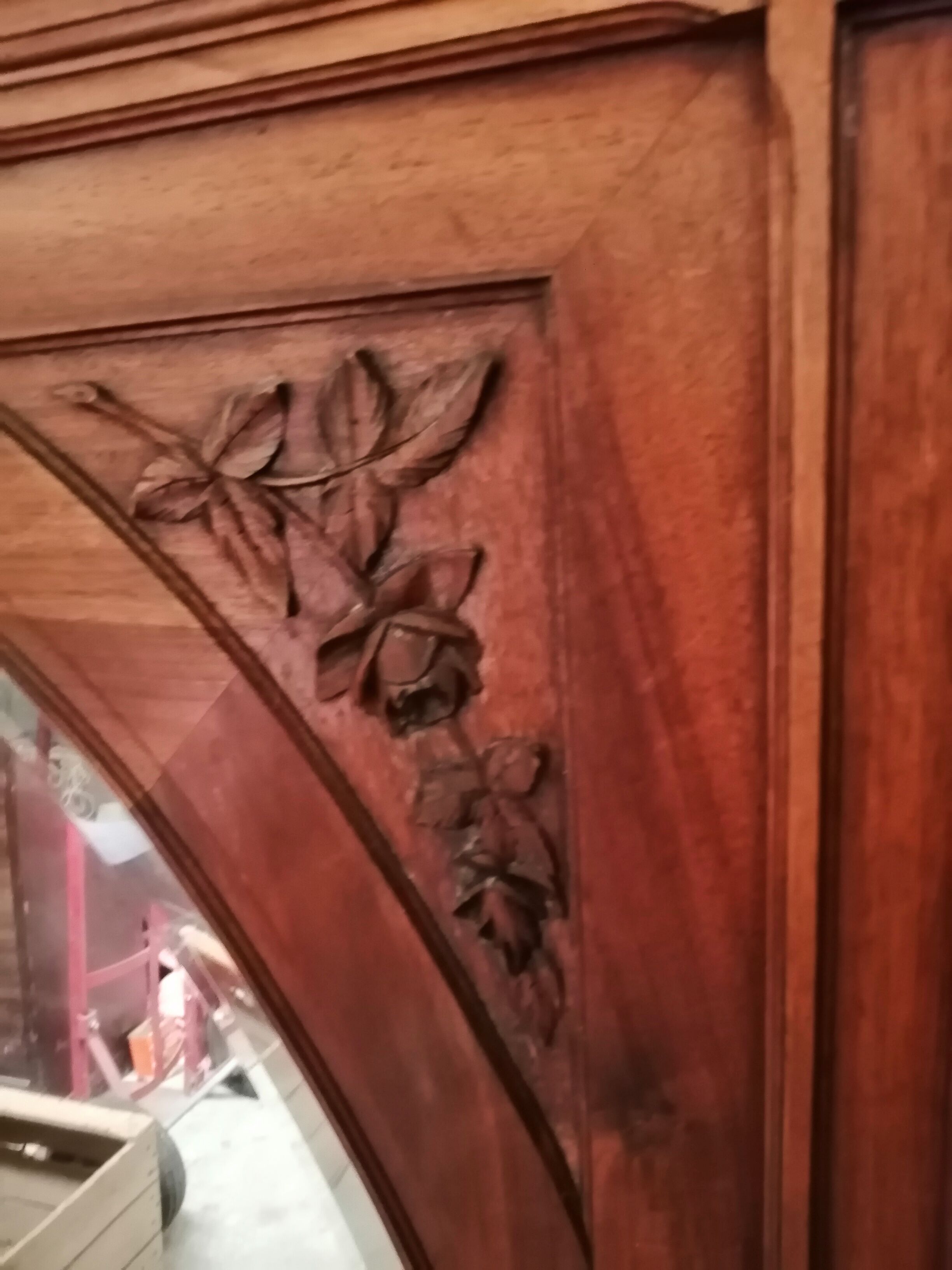 Old oval walnut wood mirror has flower carvings decoration