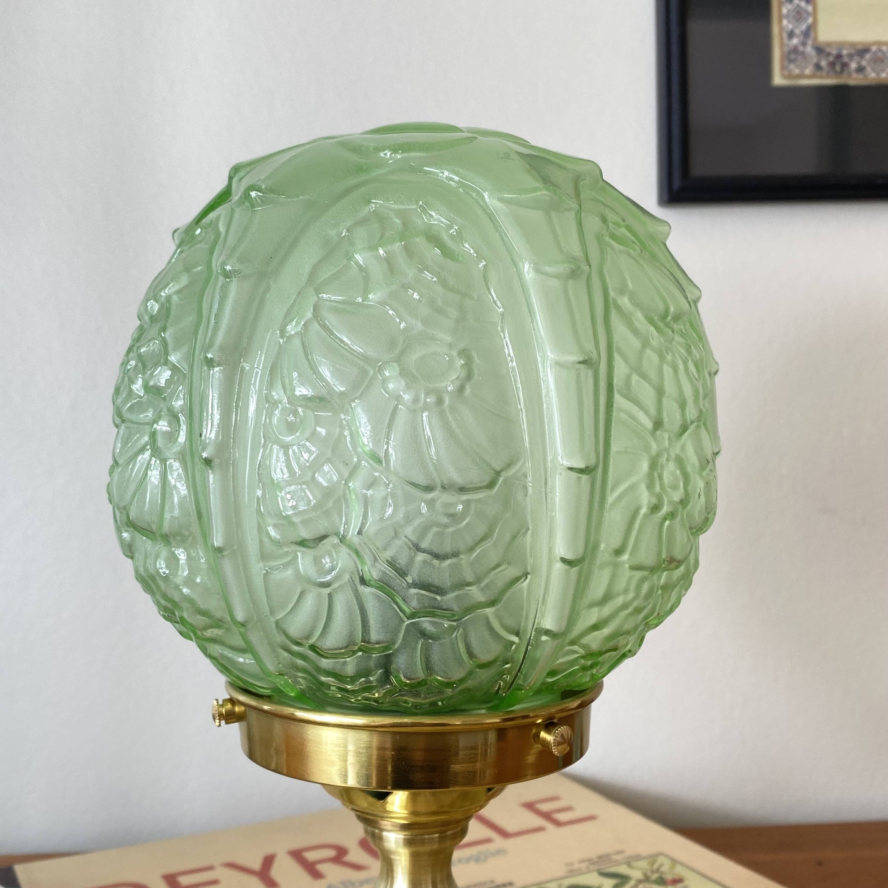 Art Deco green moulded glass globe table lamp with a brass base.