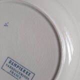 Mismatched old soup plates accompanied by a soup tureen