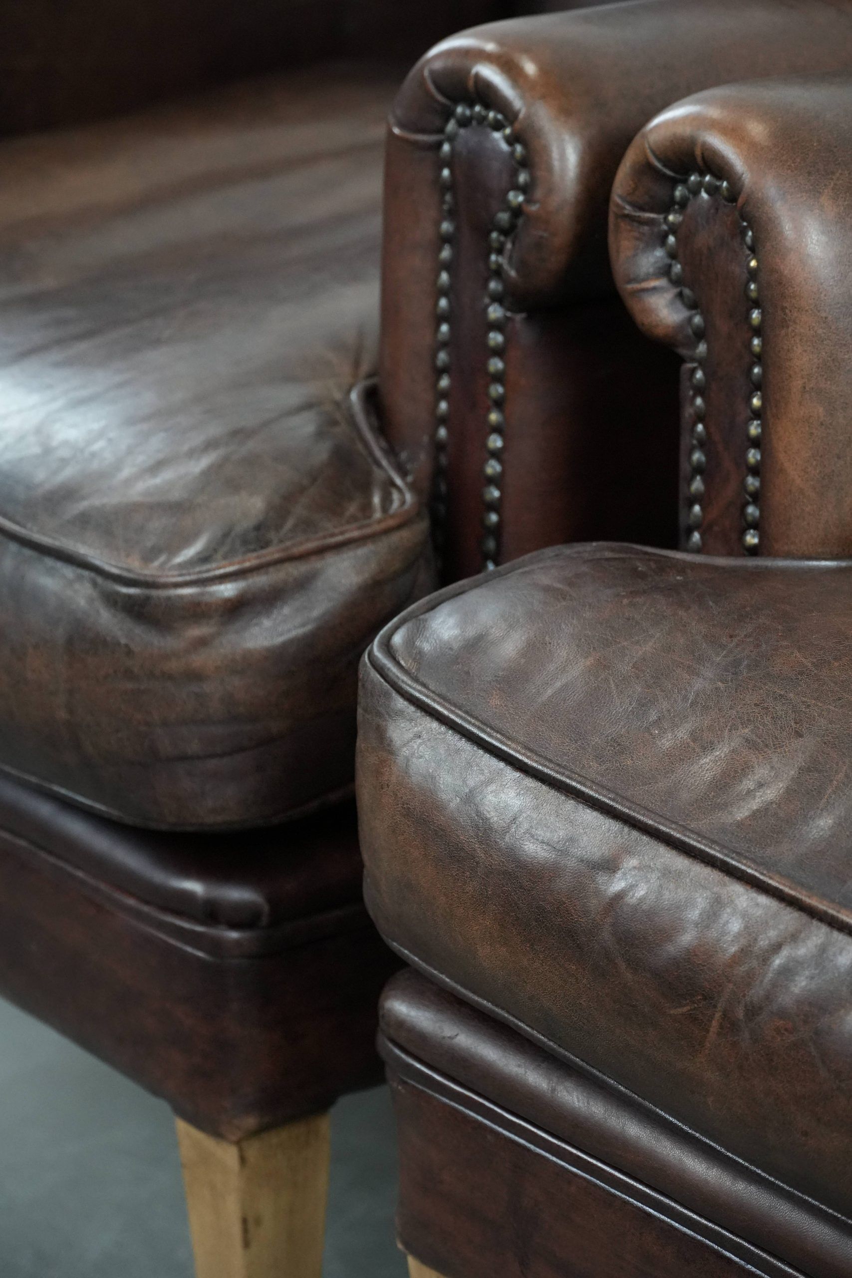 Set of two characterful sheepskin armchairs with a beautiful deep colour