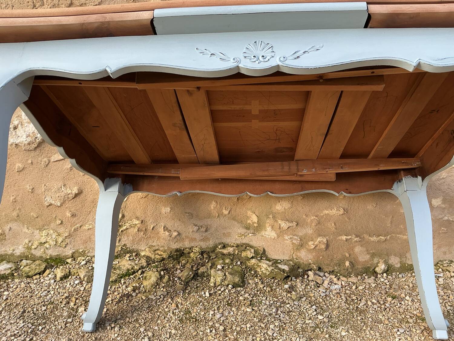 Louis XV style walnut table with a natural wood top.