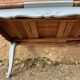 Louis XV style walnut table with a natural wood top.