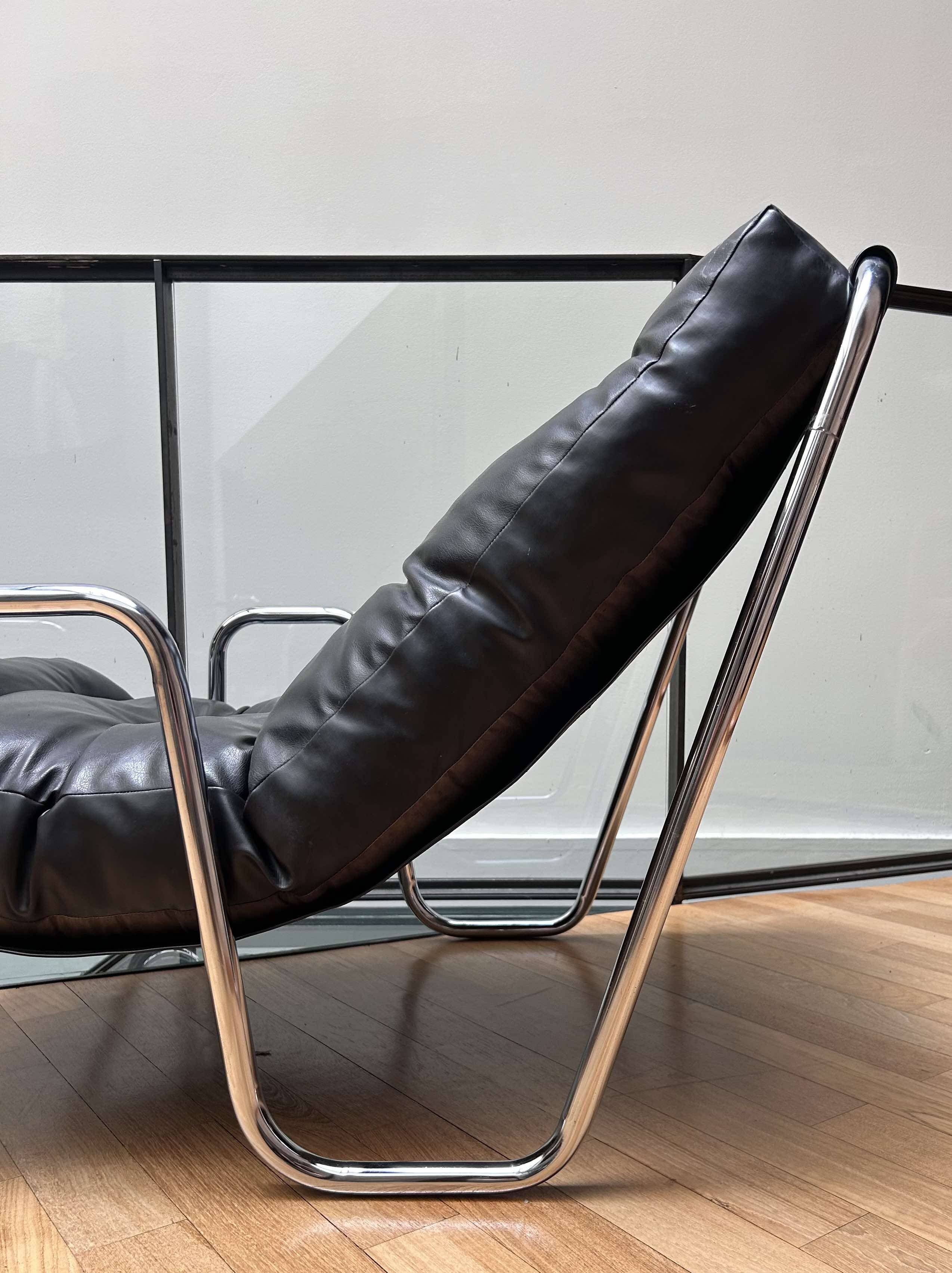 Pair of vintage armchairs in black imitation leather and chrome metal, France 1970