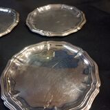 Four silver metal bottle bottoms