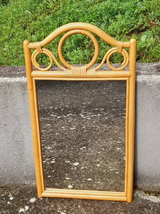 Curved wooden mirror and rattan