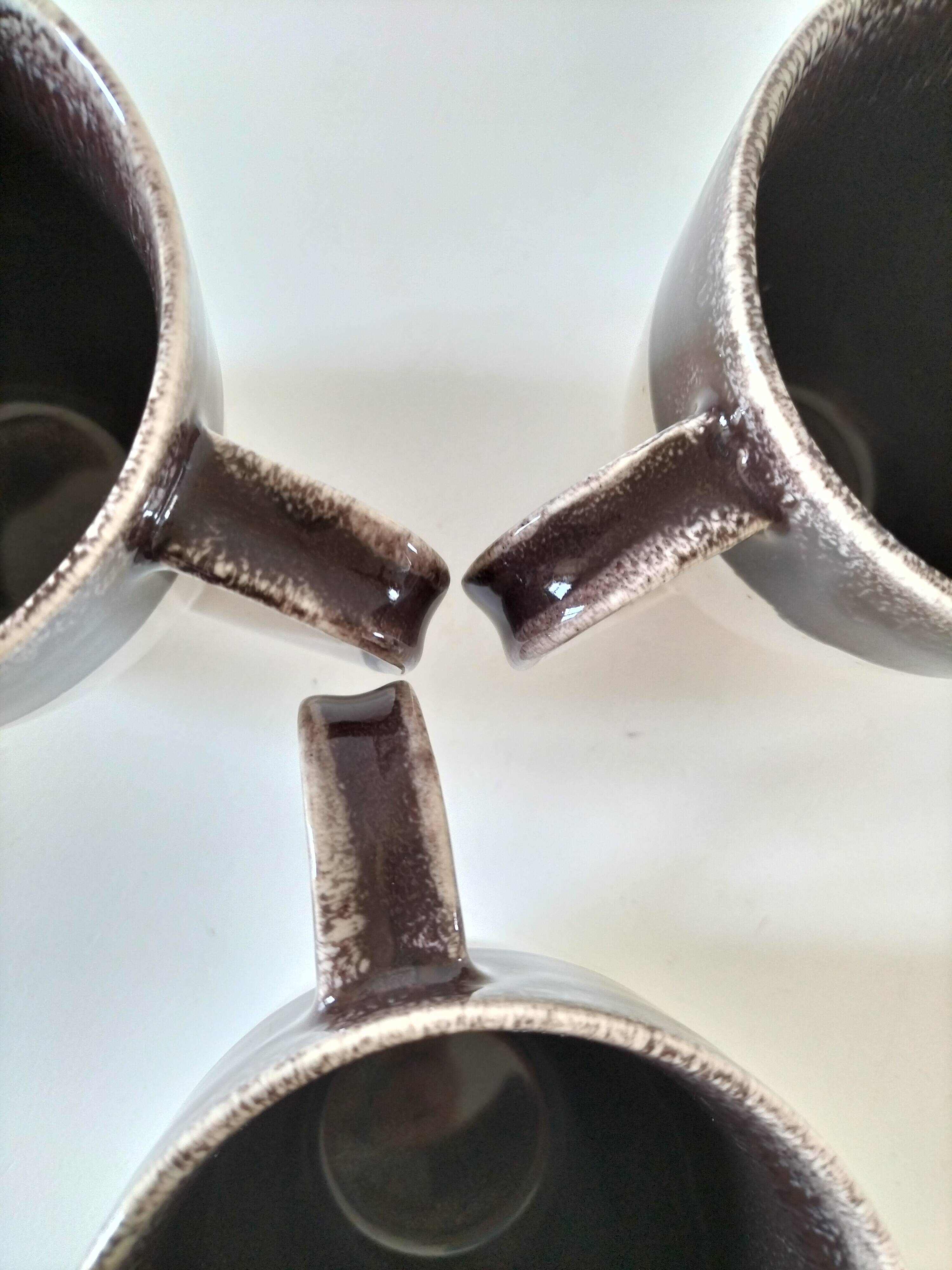 Set of three two-tone mugs, glazed stoneware, café workshop style.