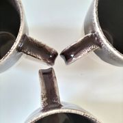 Set of three two-tone mugs, glazed stoneware, café workshop style.