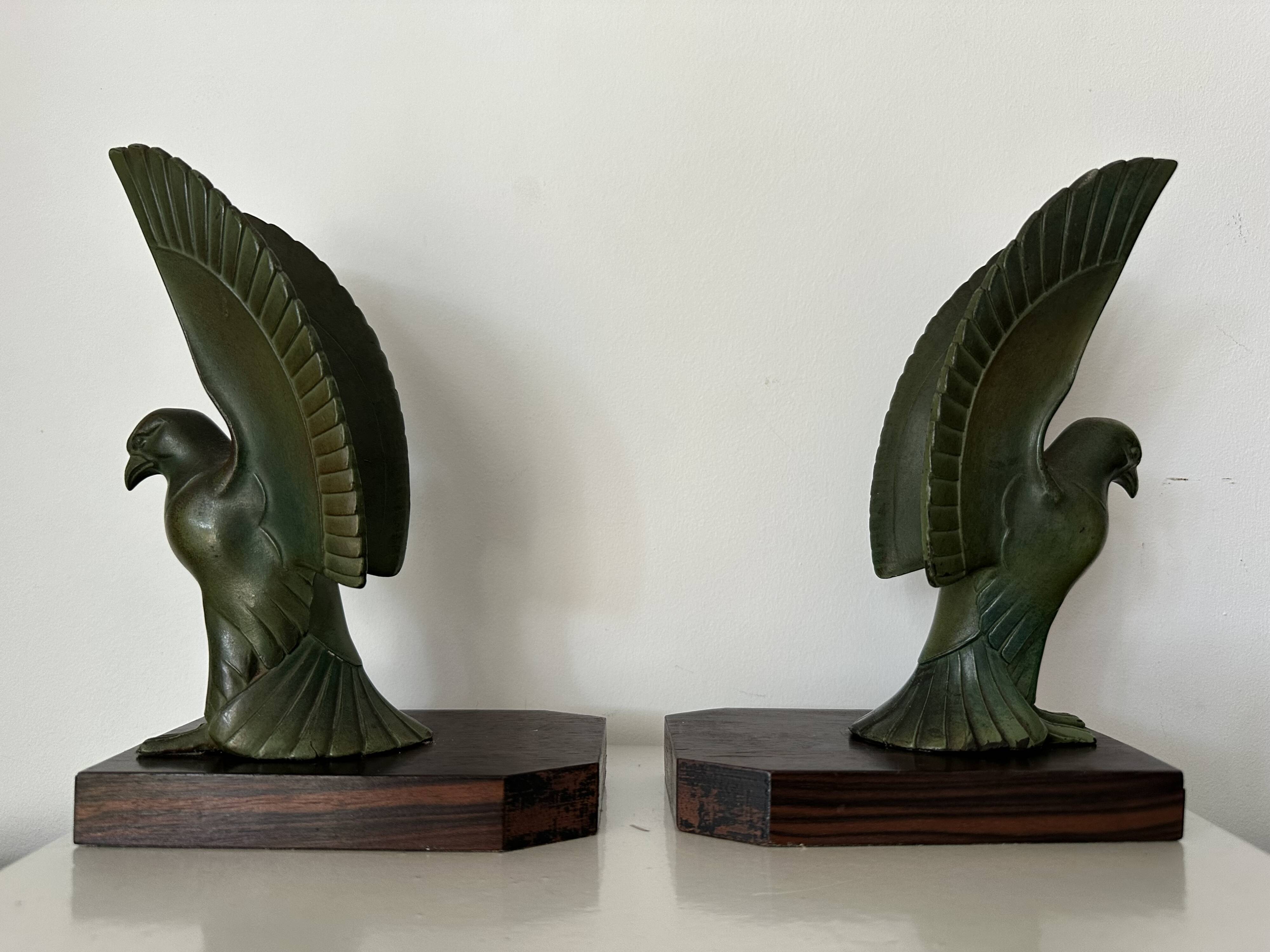 Pair of eagle bookends in green patina regula with rosewood base