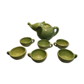 Handcrafted ceramic tea set with animal decoration.