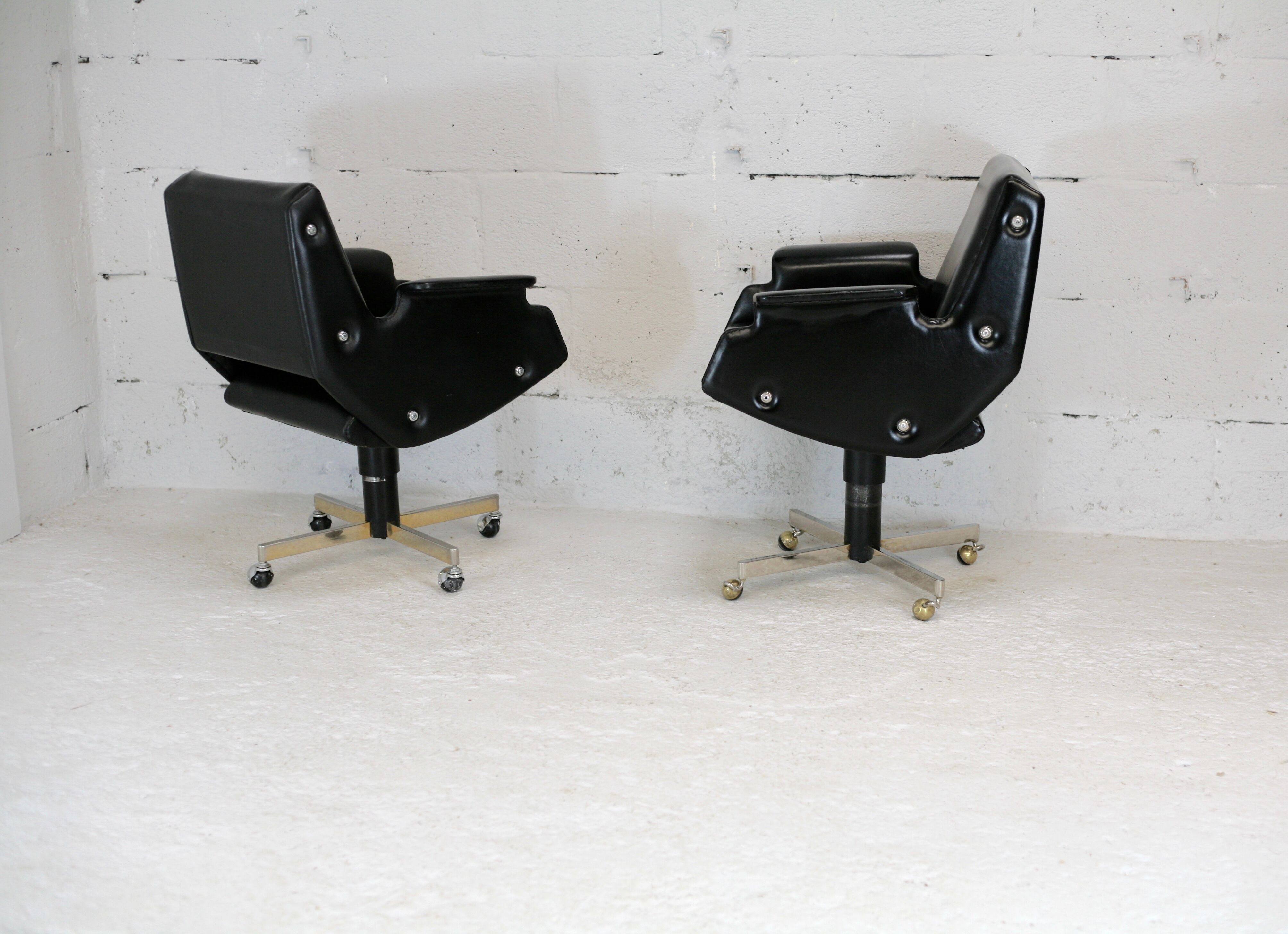 Pair of swivel armchairs, imitation leather and steel, Italy, circa 1960.