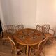 Round dining table Audoux Minet with 4 chairs and 2 armchairs.