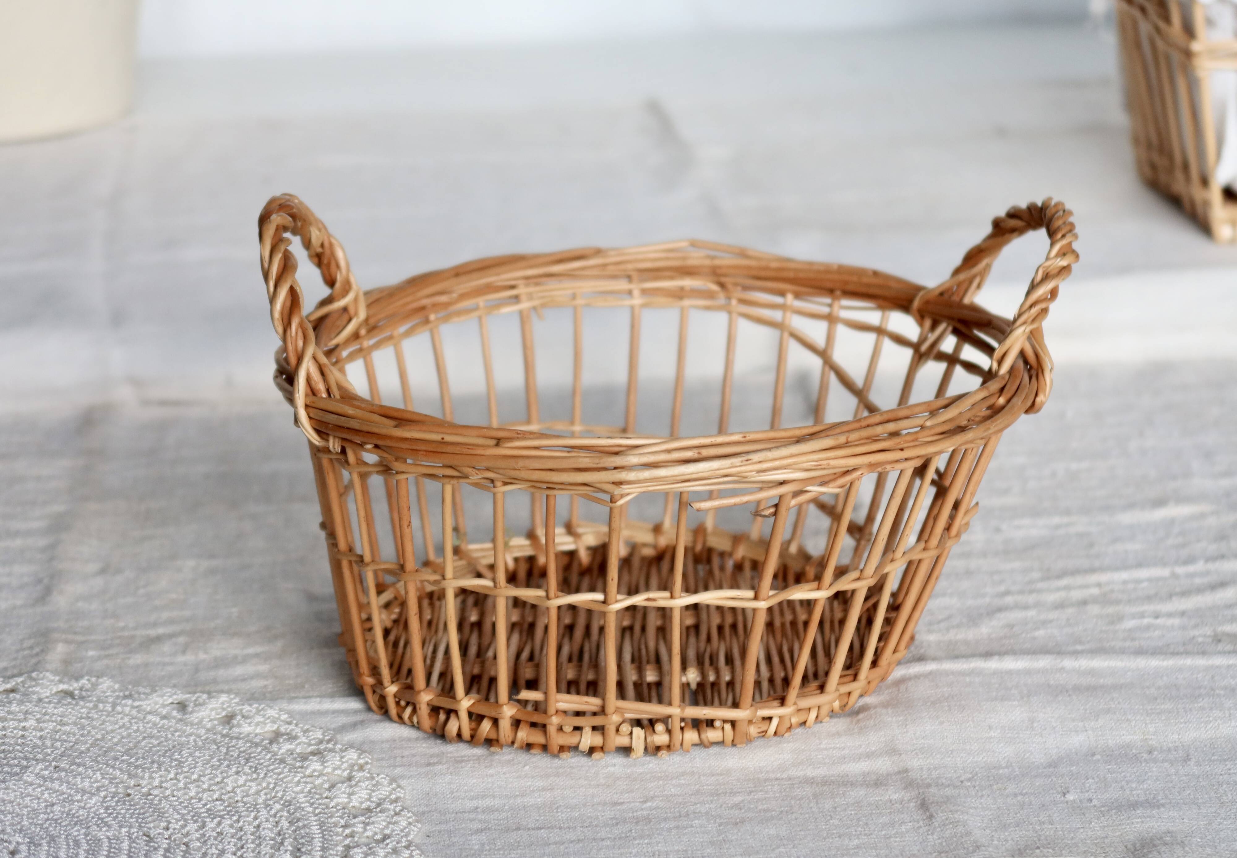 Round openwork wicker storage basket with braided handles