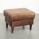 Sheepskin ottoman with a light brown colour scheme and a vintage look