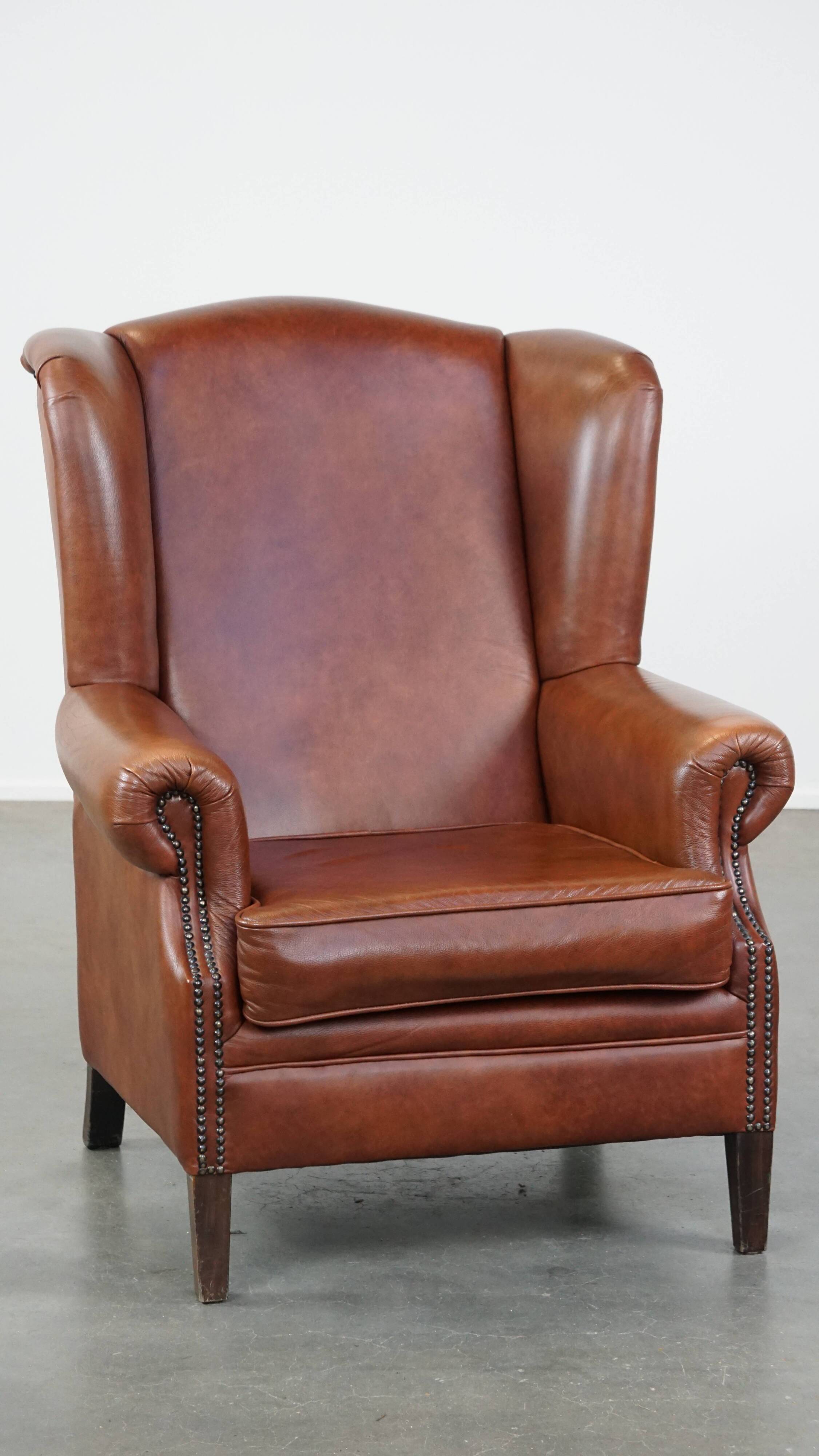 Cognac-colored cowhide wingback chair