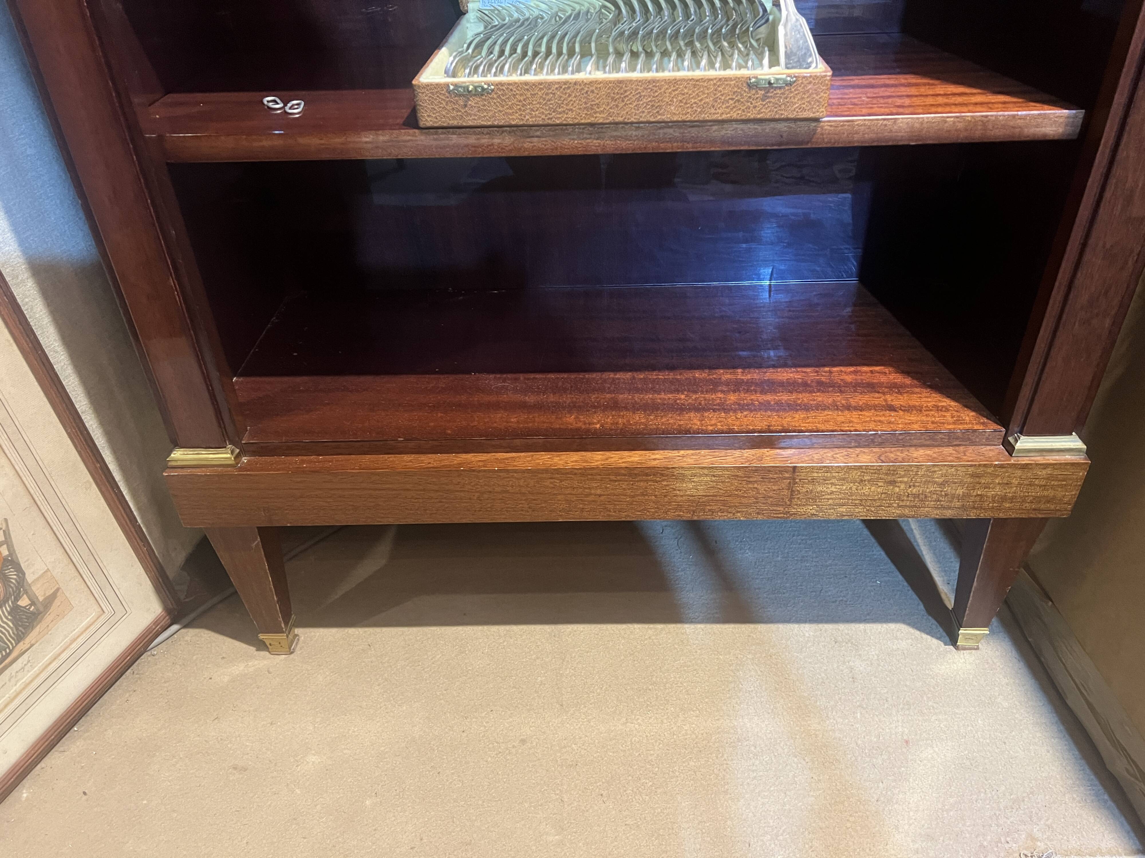 Directoire style bookcase in mahogany, decorated with gilded bronze.