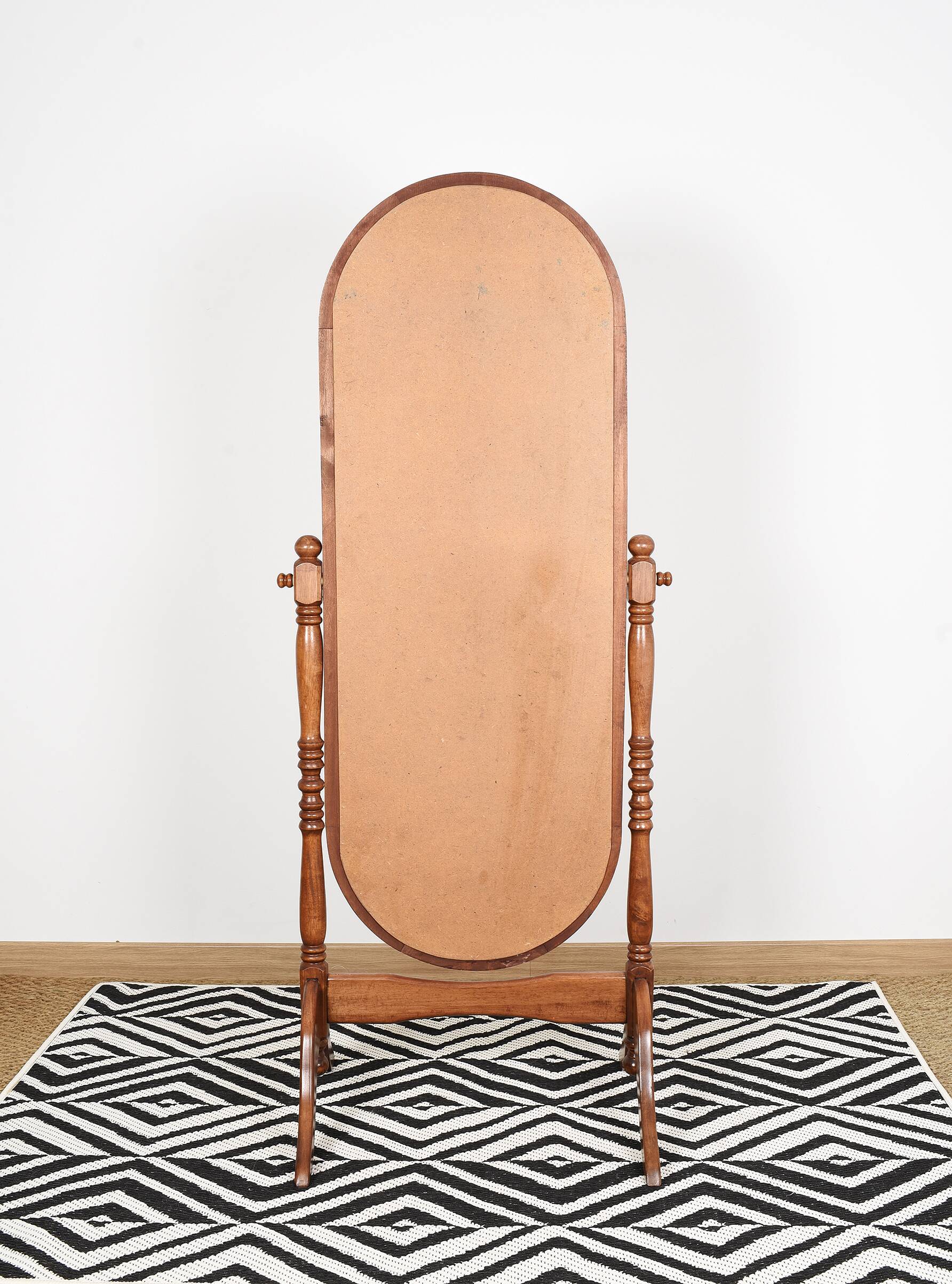 Large psychic mirror on legs with pivoting oval frame.
