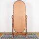 Large psychic mirror on legs with pivoting oval frame.