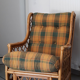 Vintage armchair in bamboo and rattan with a tartan pattern.