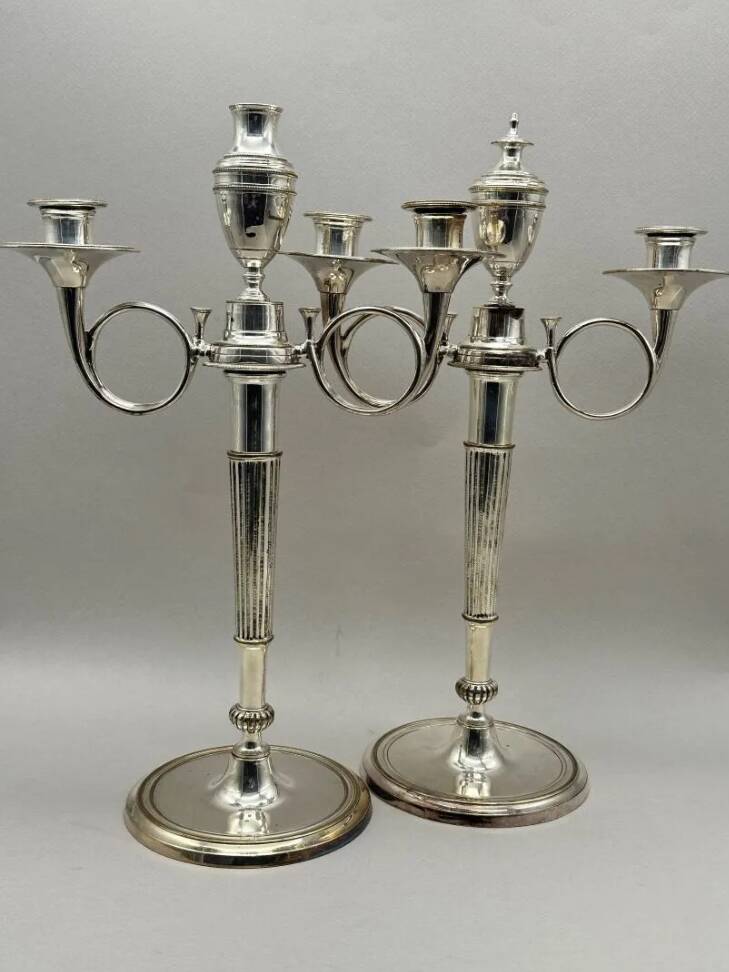 Pair of silver-plated metal candelabra decorated with hunting horns