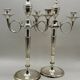 Pair of silver-plated metal candelabra decorated with hunting horns