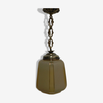 Art Deco lamp hanging on beige glass with ball chain