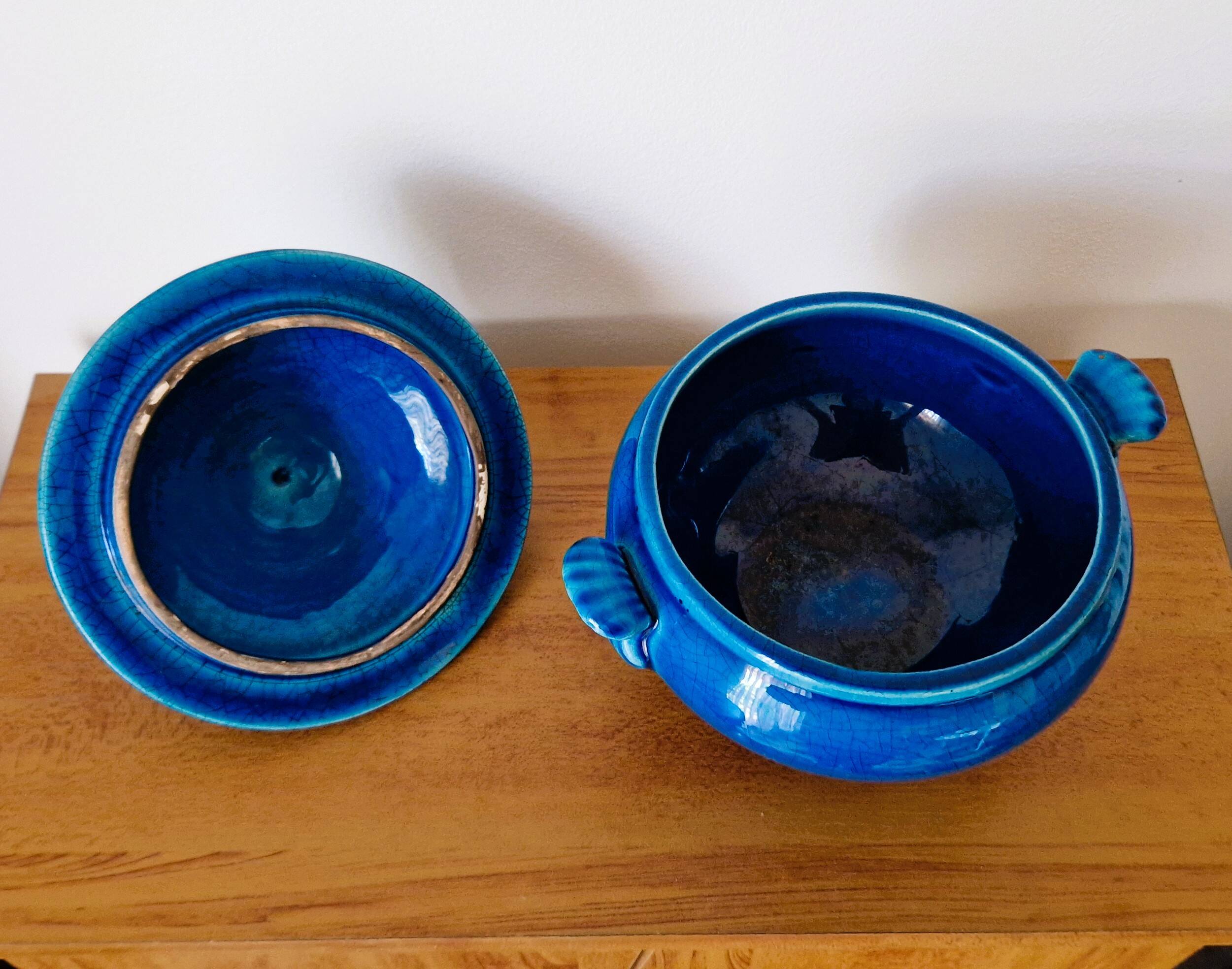 Blue ceramic soup tureen and crackled finish trivet.