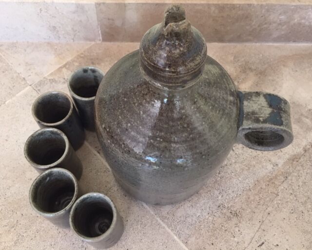 Old liquor service in sandstone, carafe and 5 glasses