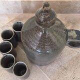 Old liquor service in sandstone, carafe and 5 glasses