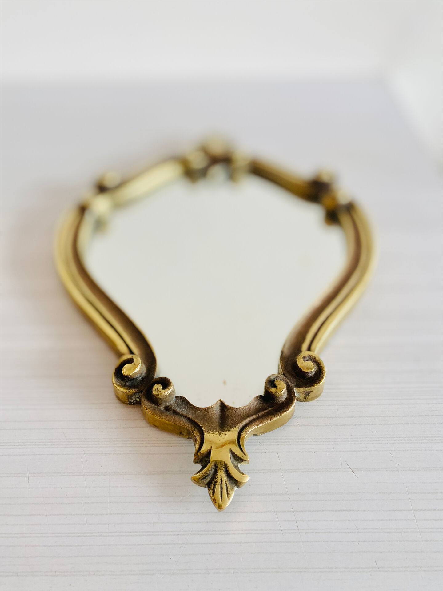 Small antique mirror in baroque style – gold frame in bronze or brass.