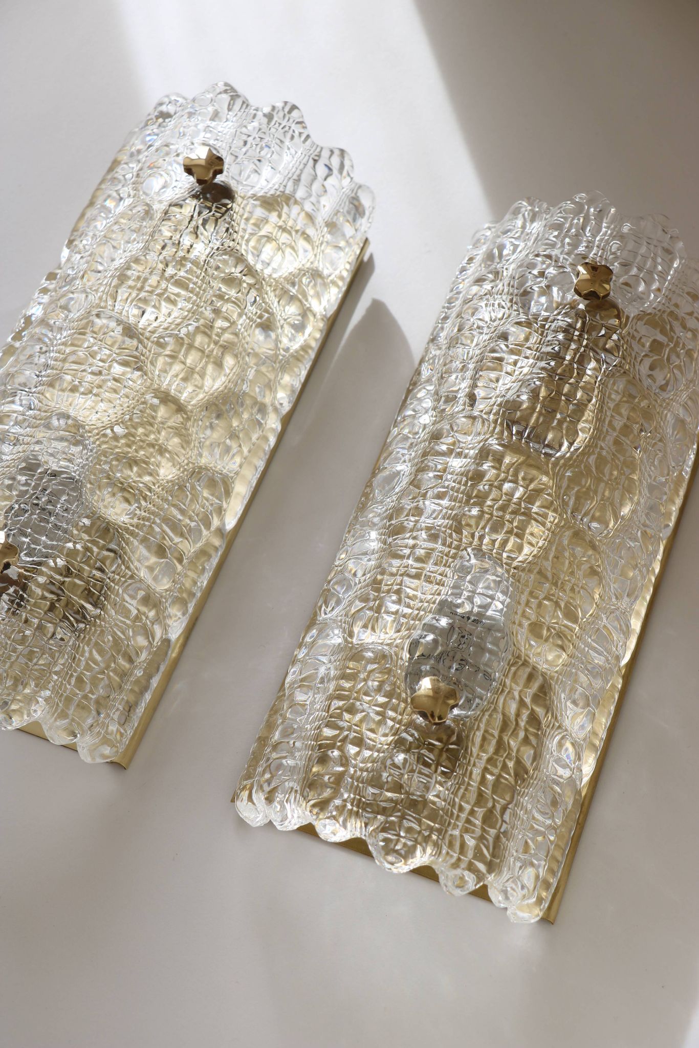 Pair of glass and brass wall lights by Carl Fagerlund for Orrefors, 1960.