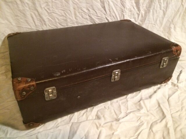 Suitcase vintage leather inside and brown carpeted home