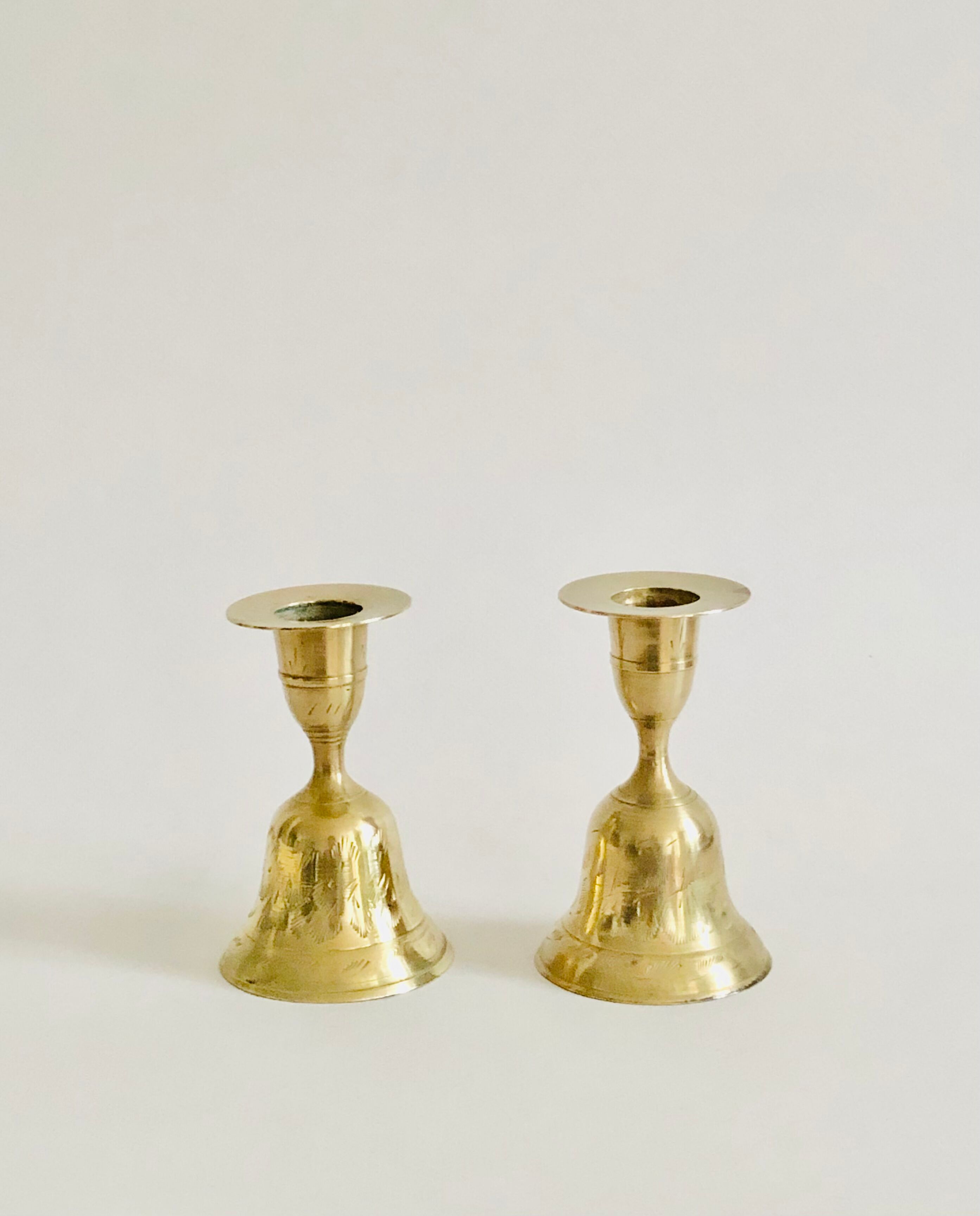 Pair of brass "bell" candle holders