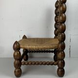 Brutalist wood turned bobbin low rush chair in the style of Charles Dudouyt