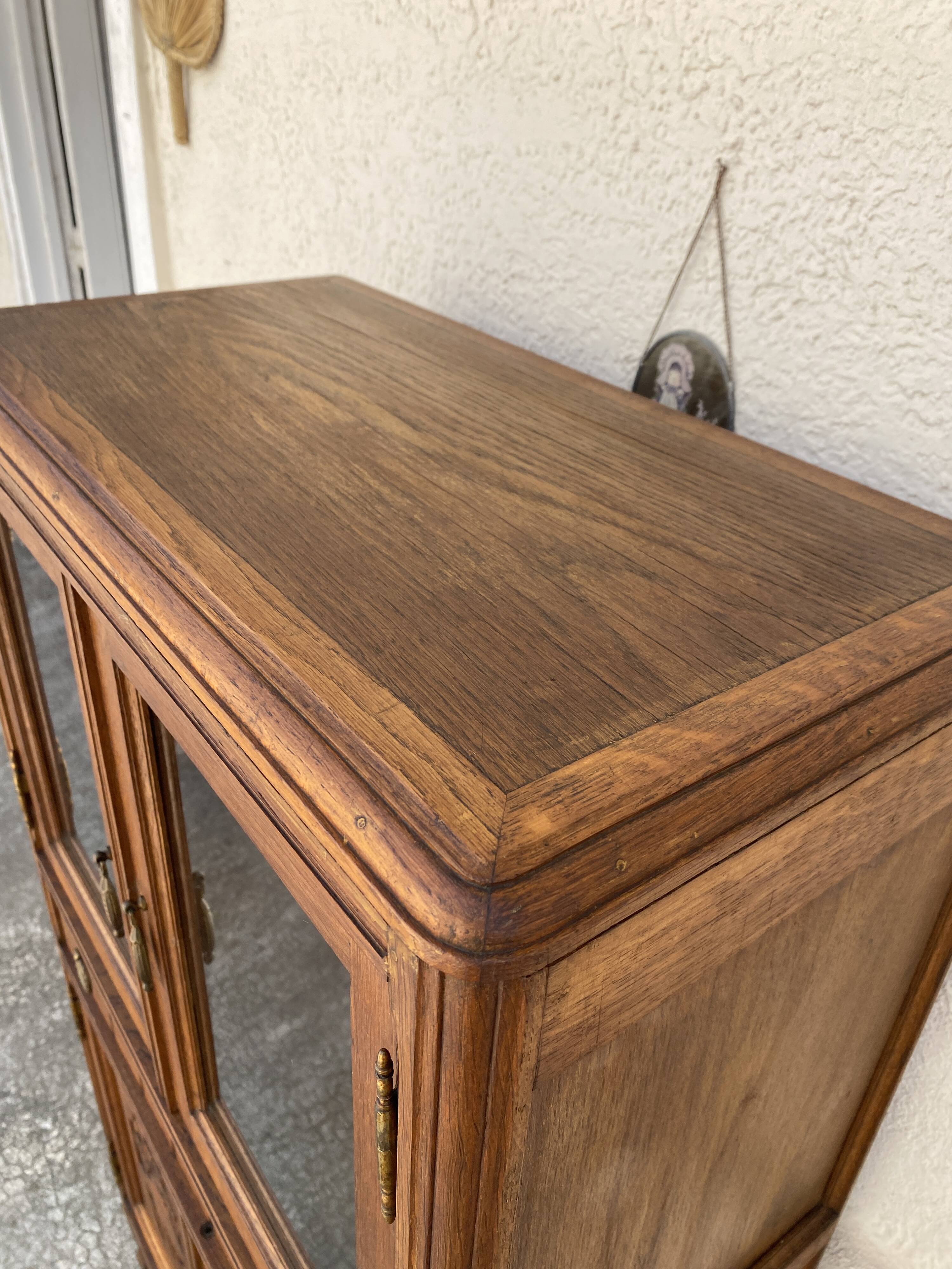 Old small glass display cabinet from the early 20th century.