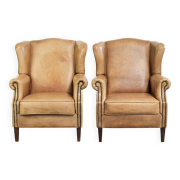 Set of two light cowhide wingback armchairs with a timeless English look