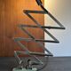 Old extendable accordion lamp in celadon green, workshop spirit.