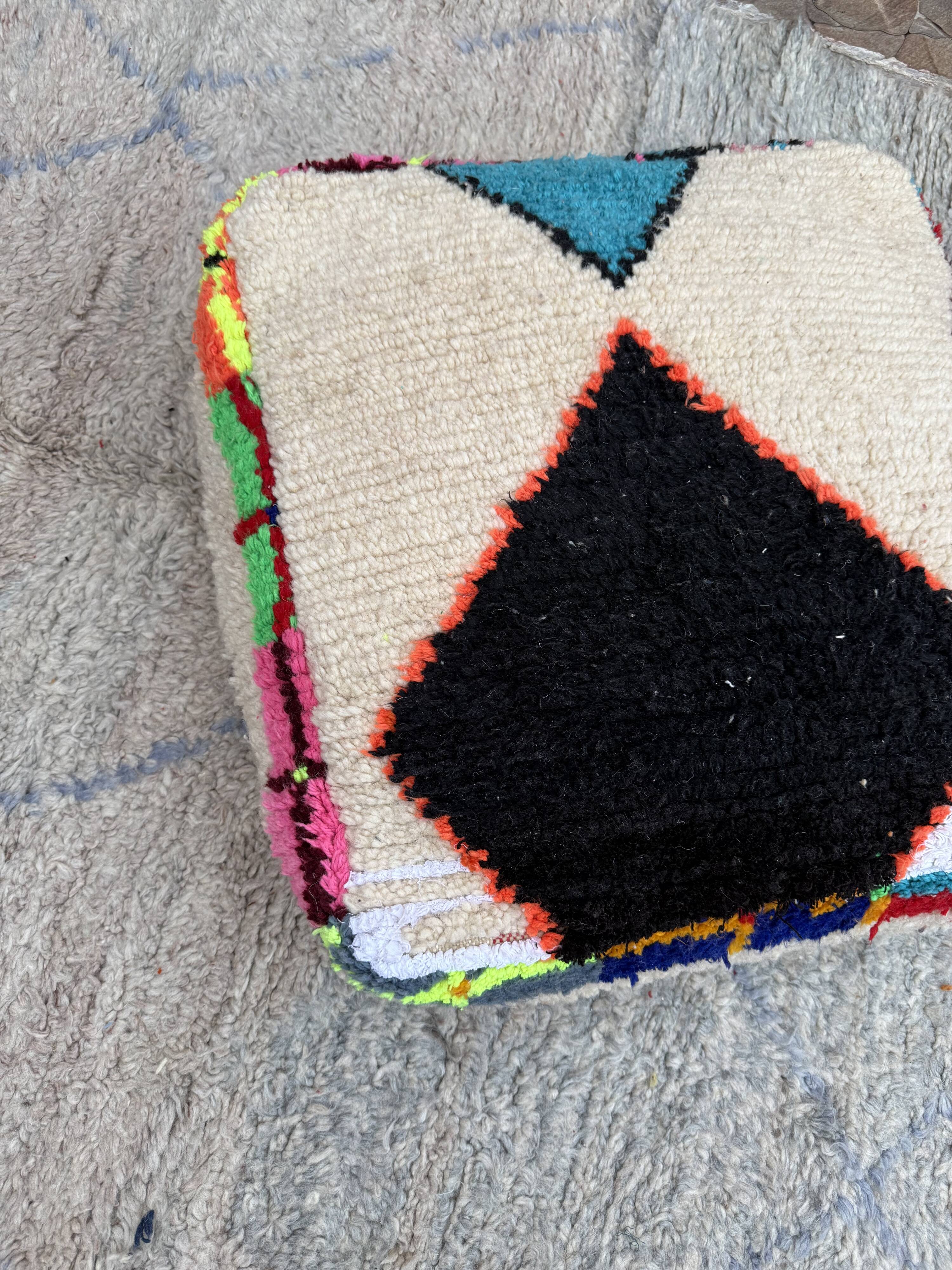 Berber floor pouf: Handwoven Moroccan wool cushion.