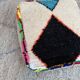 Berber floor pouf: Handwoven Moroccan wool cushion.