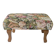 Large vintage upholstered footstool with curved legs.