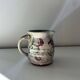 Floral decorated pitcher signed