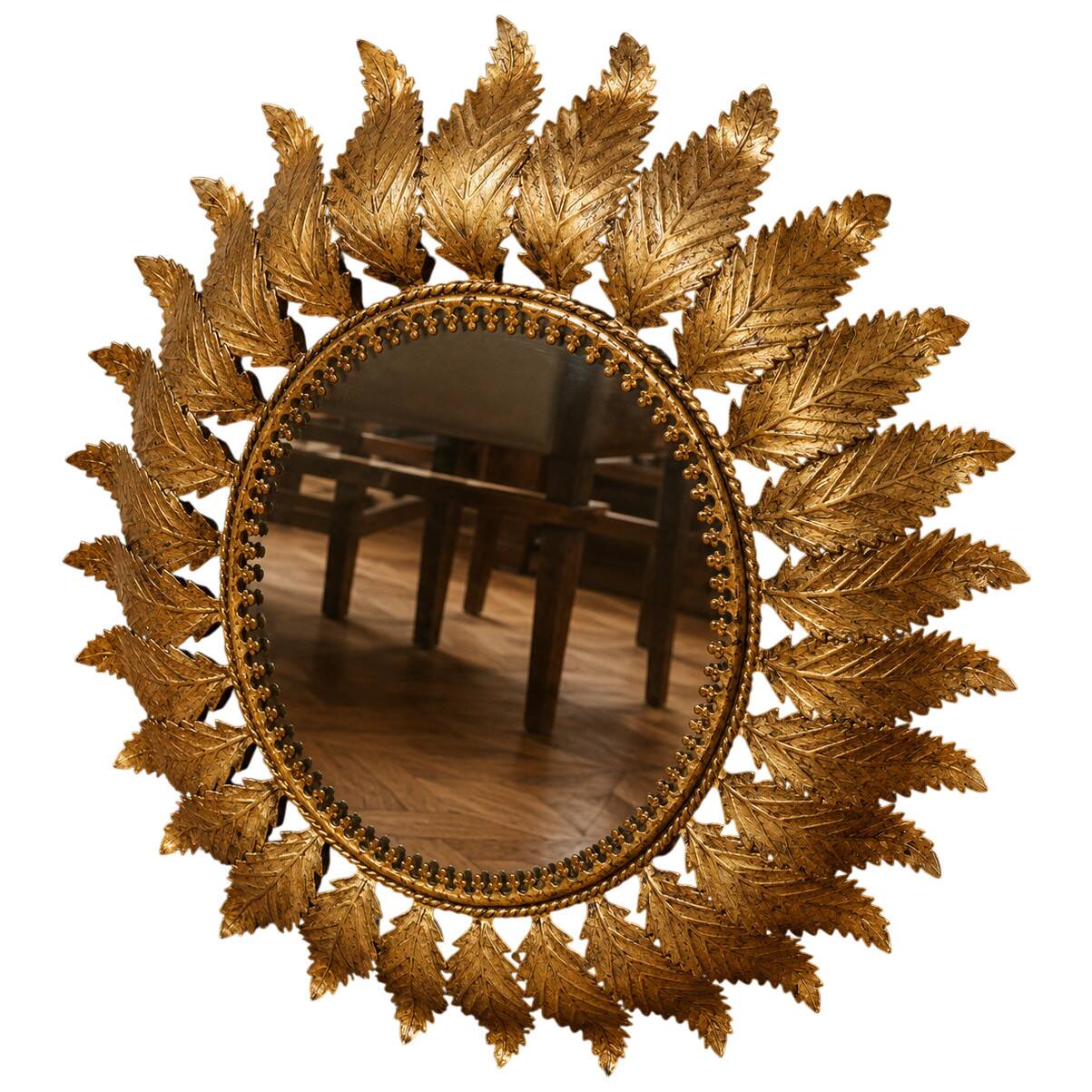 Golden metal sun mirror with leaf decoration