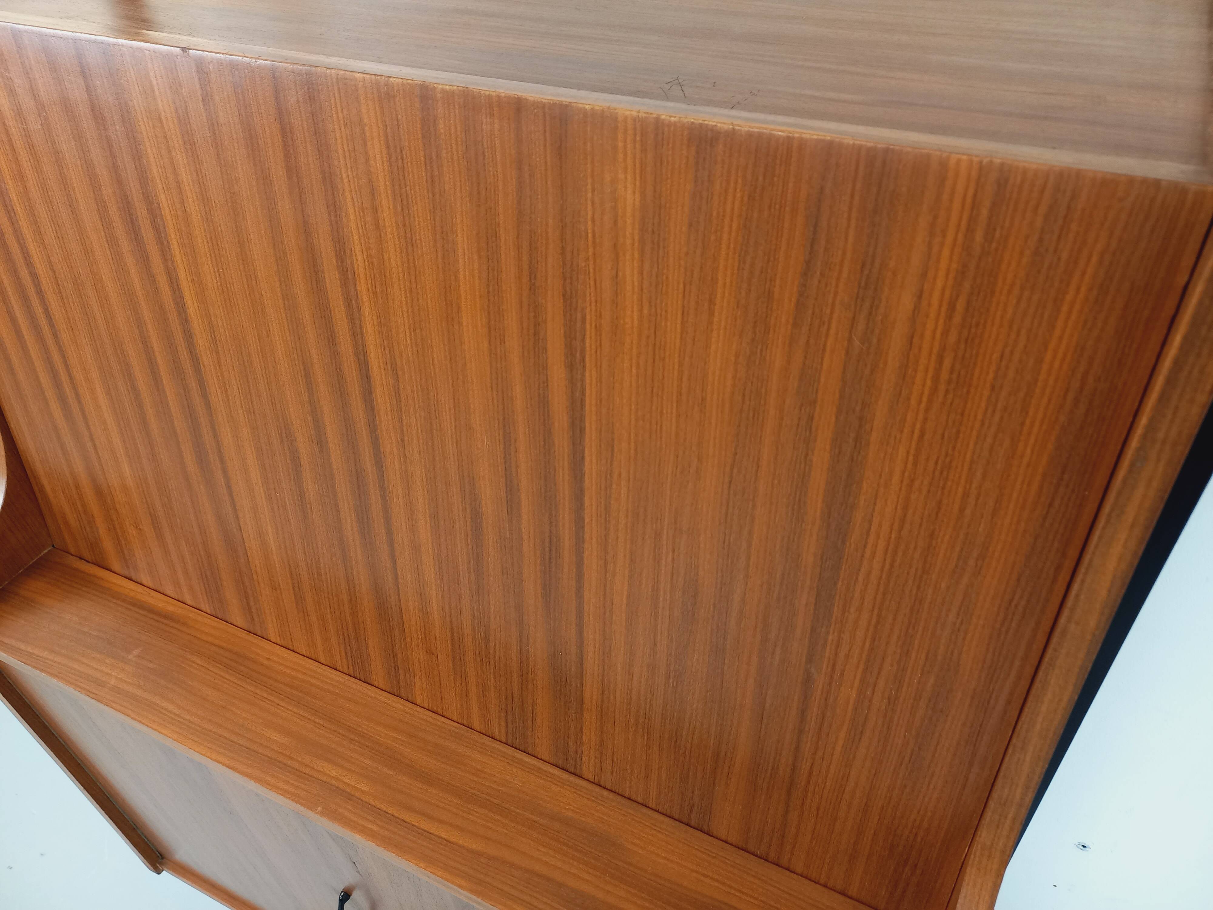 Vintage modular secretary bookshelf in teak and metal.