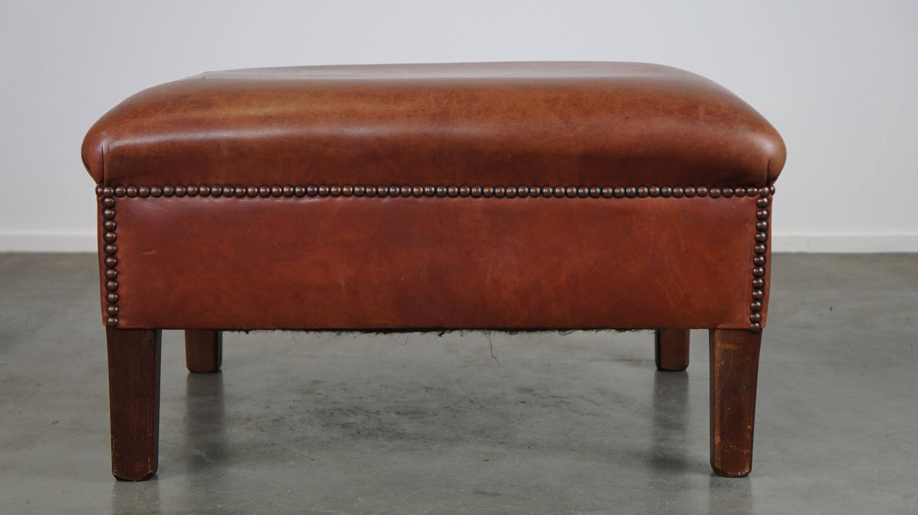 Leather ottoman in classic English style finished with decorative nails