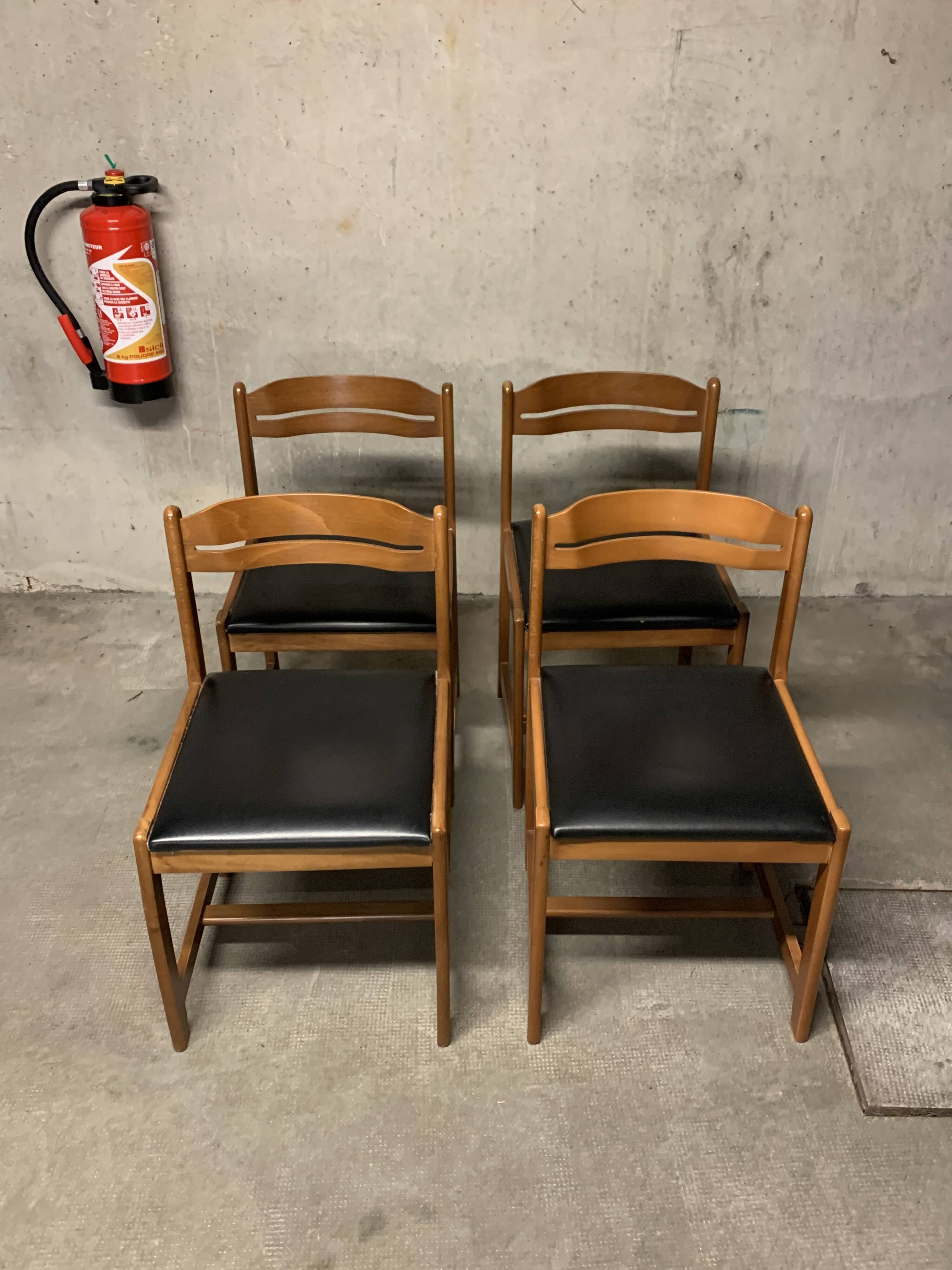 Set of four vintage chairs upholstered in retro design faux leather.